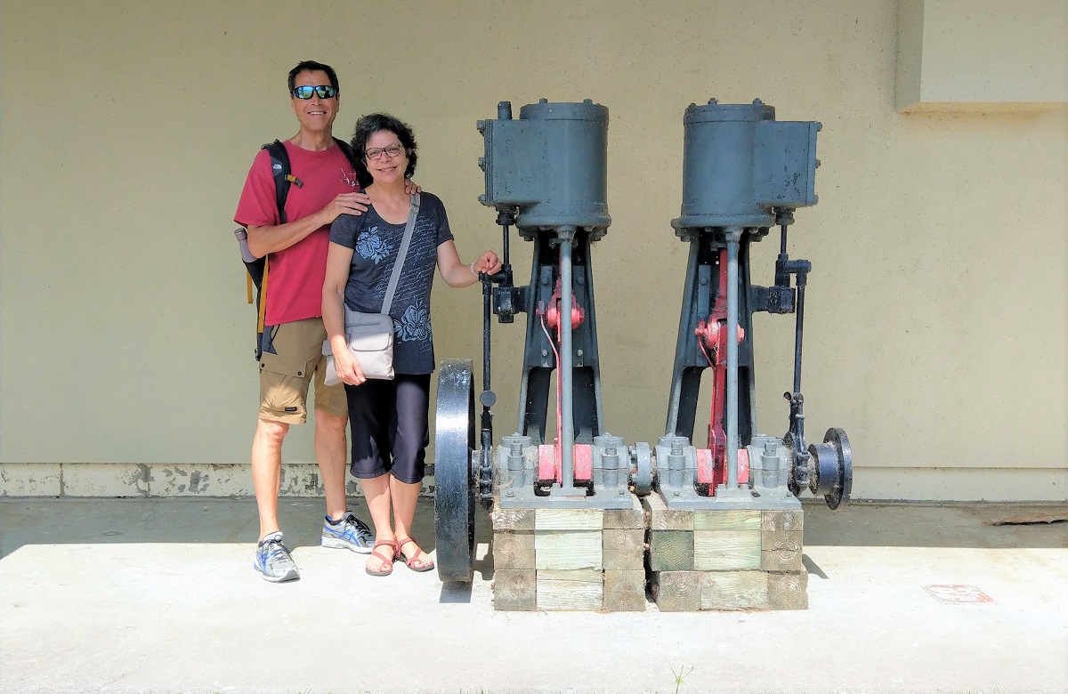 A man and woman standing next to a pump